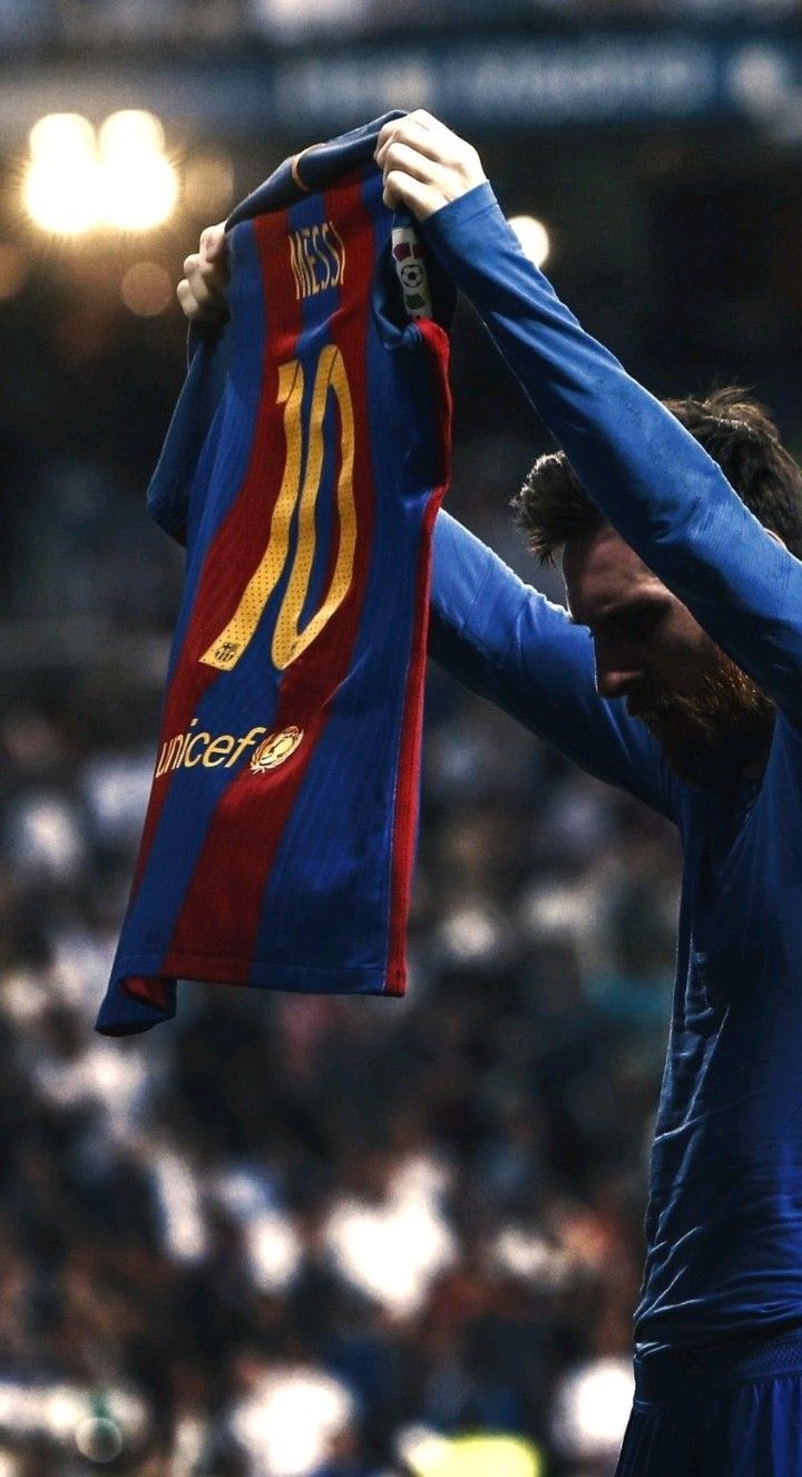 Messi celebrates after he scores a last-minute goal.